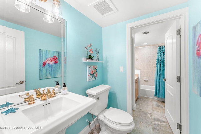 full bathroom featuring shower / bath combination with curtain, toilet, and sink