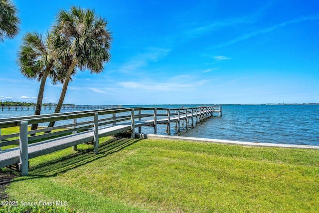 dock area featuring a yard and a water view