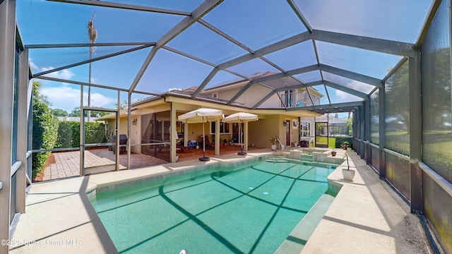 view of swimming pool with a lanai and a patio area