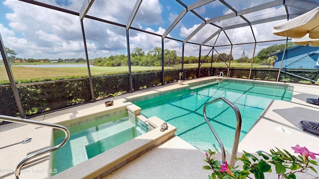 view of pool with a lanai, a water view, a patio, and an in ground hot tub