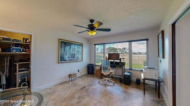 office space with ceiling fan and a textured ceiling