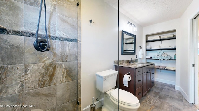 bathroom featuring a textured ceiling, toilet, and vanity