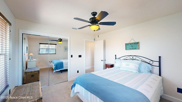 bedroom featuring ceiling fan, light colored carpet, and a closet