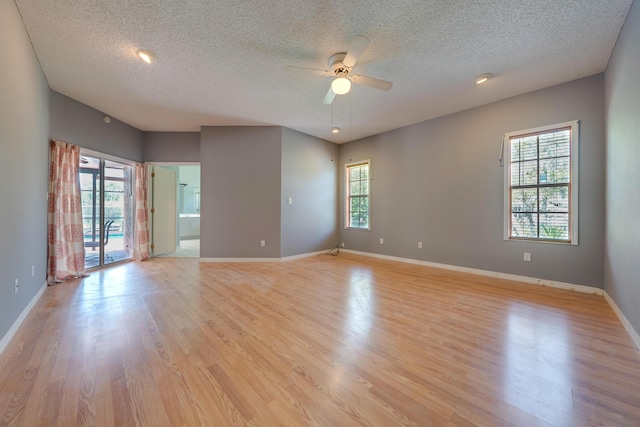 unfurnished room with ceiling fan, plenty of natural light, and light hardwood / wood-style flooring