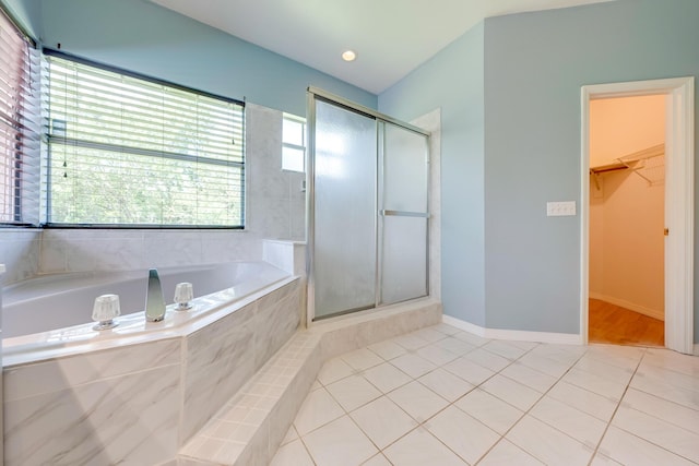 bathroom featuring tile patterned flooring and shower with separate bathtub