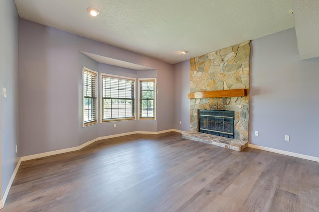 unfurnished living room with a fireplace and hardwood / wood-style floors