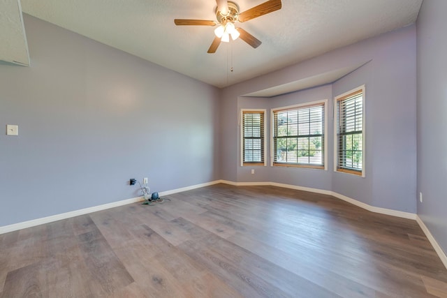 unfurnished room with ceiling fan and hardwood / wood-style floors