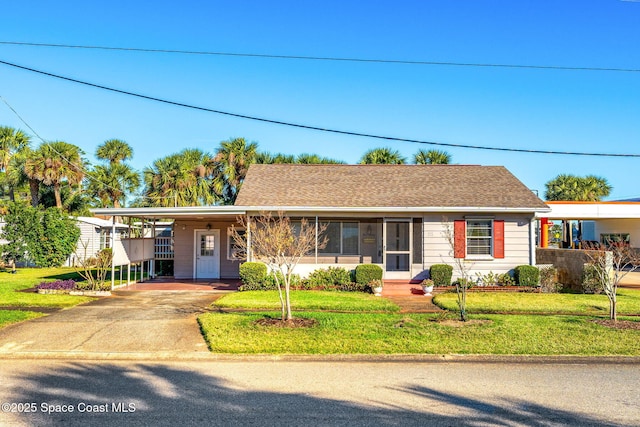 ranch-style house with a front yard and a carport