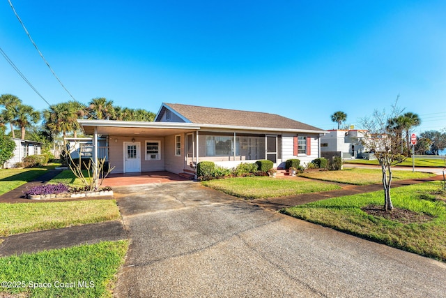 ranch-style house featuring a carport and a front yard