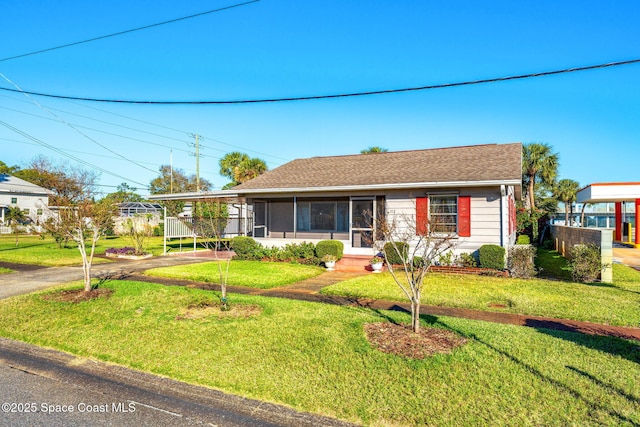 ranch-style house featuring a front lawn and a carport