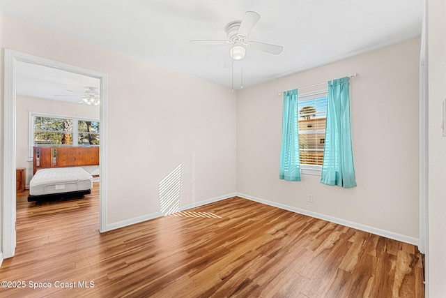 spare room with ceiling fan and hardwood / wood-style floors