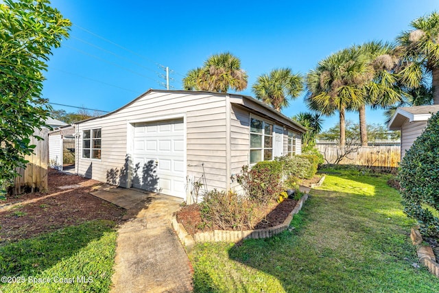 exterior space with a garage and a lawn