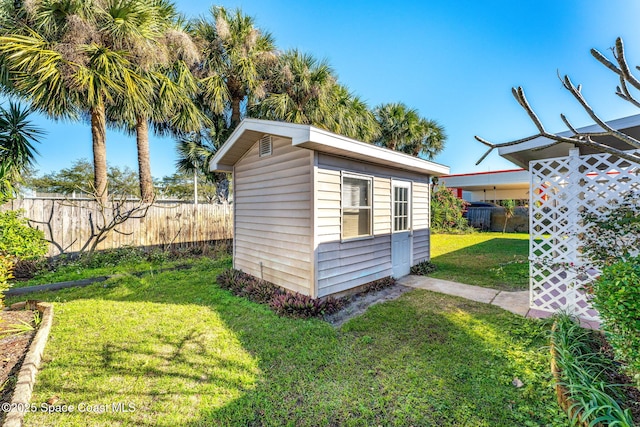 view of outbuilding featuring a yard