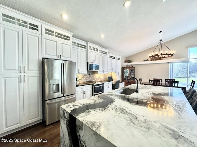 kitchen with sink, white cabinets, stainless steel appliances, and tasteful backsplash