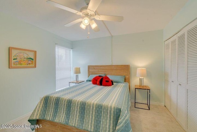 carpeted bedroom featuring ceiling fan and a closet