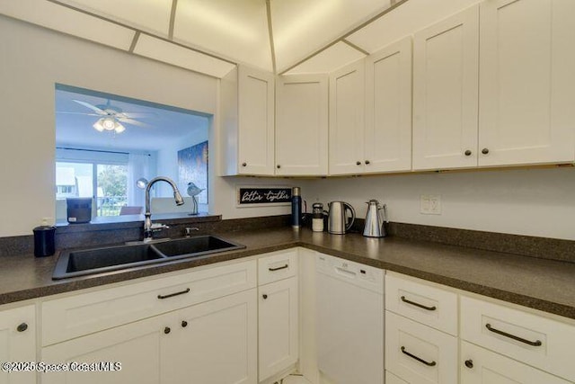 kitchen featuring white dishwasher, sink, white cabinetry, and ceiling fan