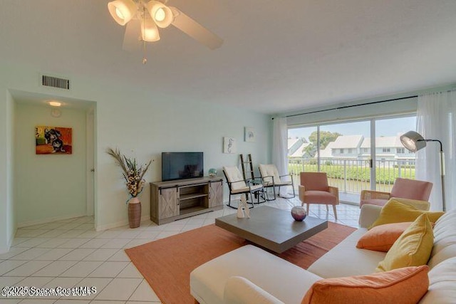 tiled living room with ceiling fan