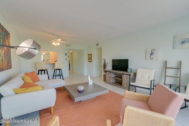 living room with ceiling fan and light tile patterned floors