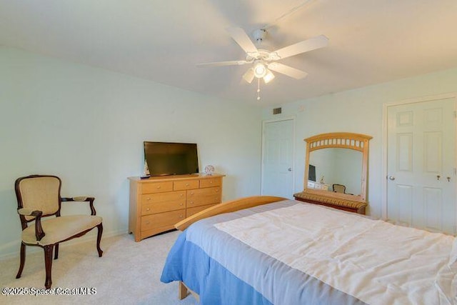 bedroom with ceiling fan and light carpet