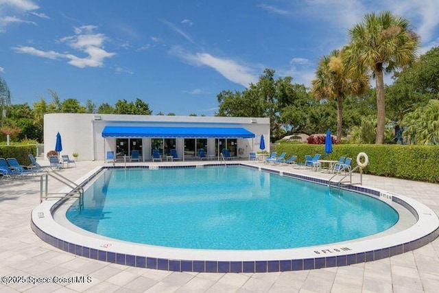 view of swimming pool with a patio