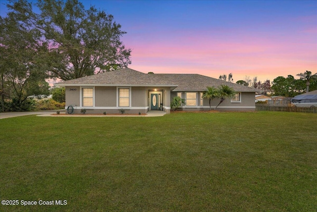 ranch-style house featuring a lawn