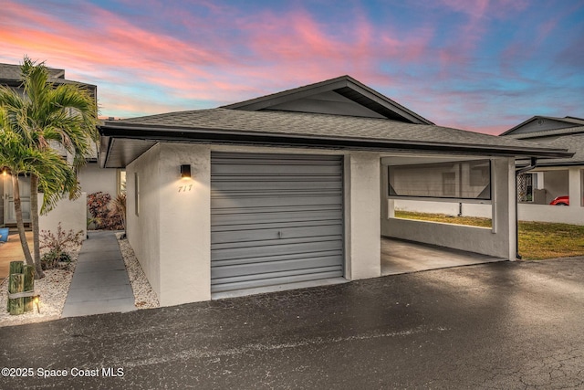 view of garage at dusk