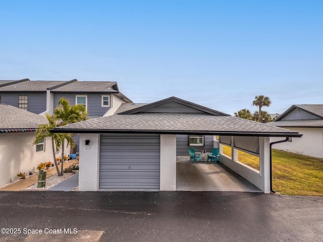 view of front facade featuring a garage and a carport