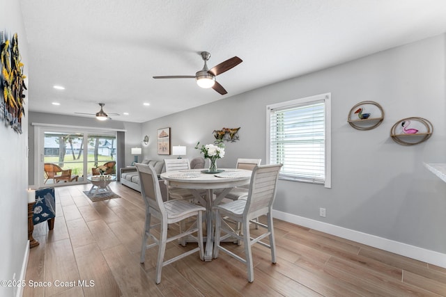 dining space featuring ceiling fan and light hardwood / wood-style floors