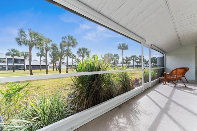 sunroom featuring lofted ceiling