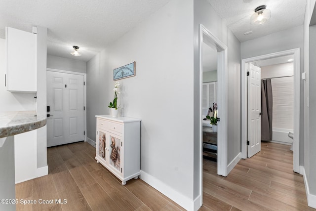 hall with a textured ceiling