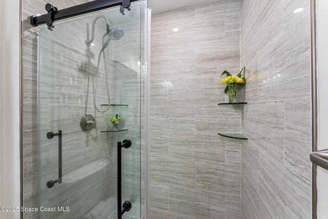 bathroom featuring a shower with shower door