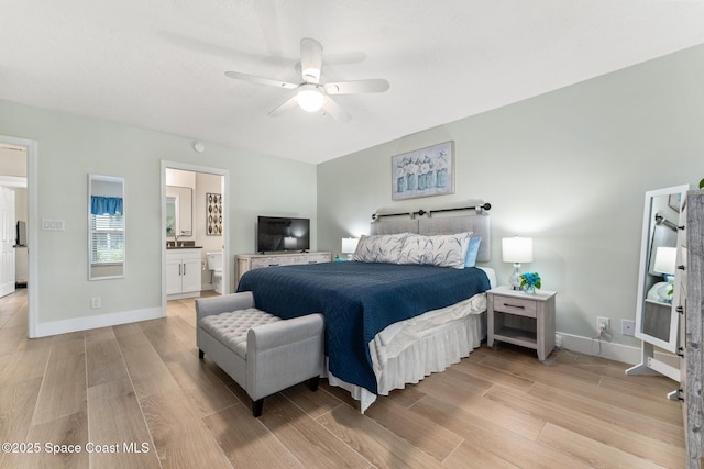 bedroom featuring ceiling fan, light hardwood / wood-style floors, and ensuite bathroom