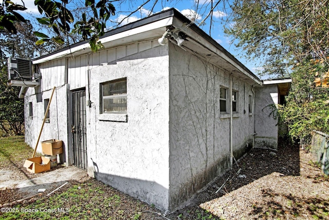 view of property exterior with central AC