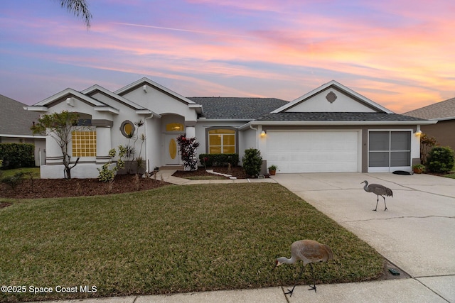 ranch-style home with a lawn and a garage