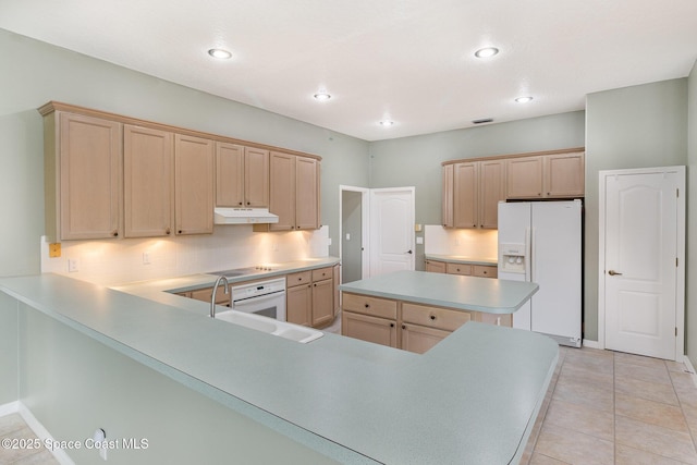 kitchen featuring light brown cabinetry, sink, white appliances, and light tile patterned flooring