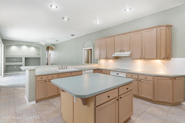 kitchen featuring kitchen peninsula, light brown cabinets, sink, a kitchen island, and built in shelves