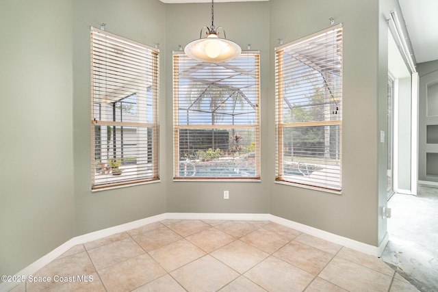 unfurnished dining area with a healthy amount of sunlight and light tile patterned flooring