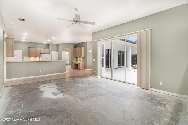 unfurnished living room with ceiling fan