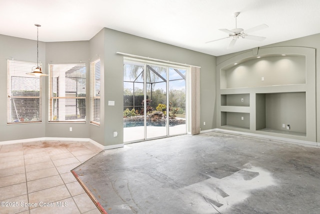 unfurnished living room with ceiling fan, built in shelves, and light tile patterned floors