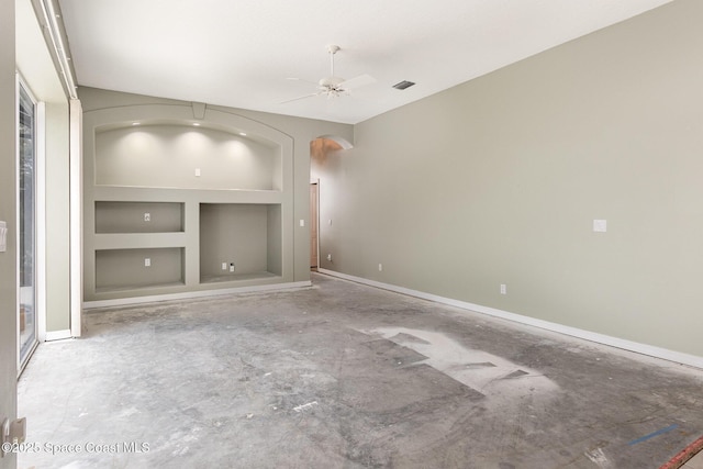 unfurnished living room with ceiling fan, built in features, and concrete flooring