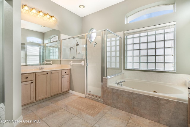 bathroom featuring a wealth of natural light, tile patterned flooring, and independent shower and bath