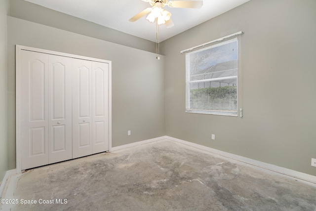 unfurnished bedroom with ceiling fan and a closet