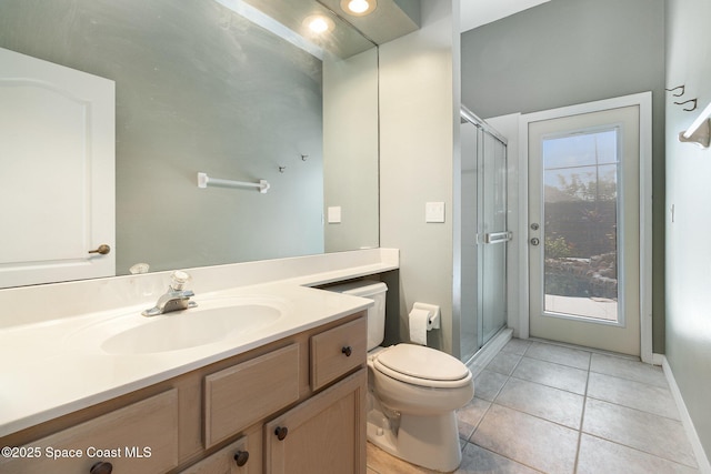 bathroom with an enclosed shower, vanity, tile patterned floors, and toilet