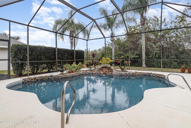 view of swimming pool with a patio area and a lanai