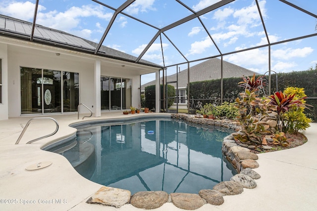 view of swimming pool with a lanai and a patio