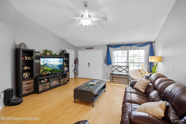 living room featuring ceiling fan, lofted ceiling, and hardwood / wood-style floors