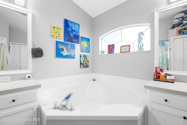 bathroom featuring shower with separate bathtub, vanity, and vaulted ceiling