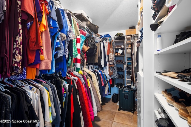 walk in closet featuring light tile patterned flooring