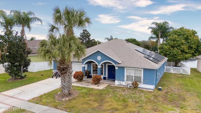 ranch-style home with covered porch, a front lawn, and solar panels