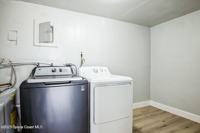 washroom featuring independent washer and dryer, light hardwood / wood-style flooring, and electric water heater